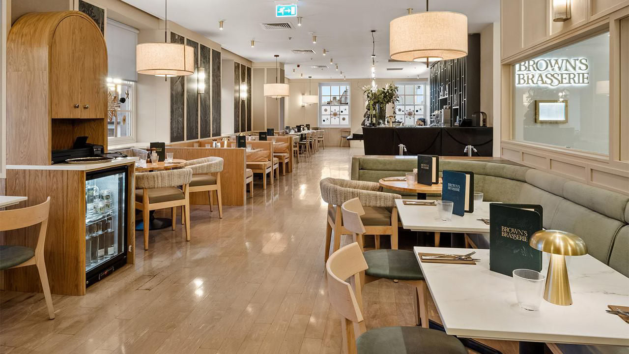 
Elegant interior of Brown's Brasserie with wooden furniture and ambient lighting.
